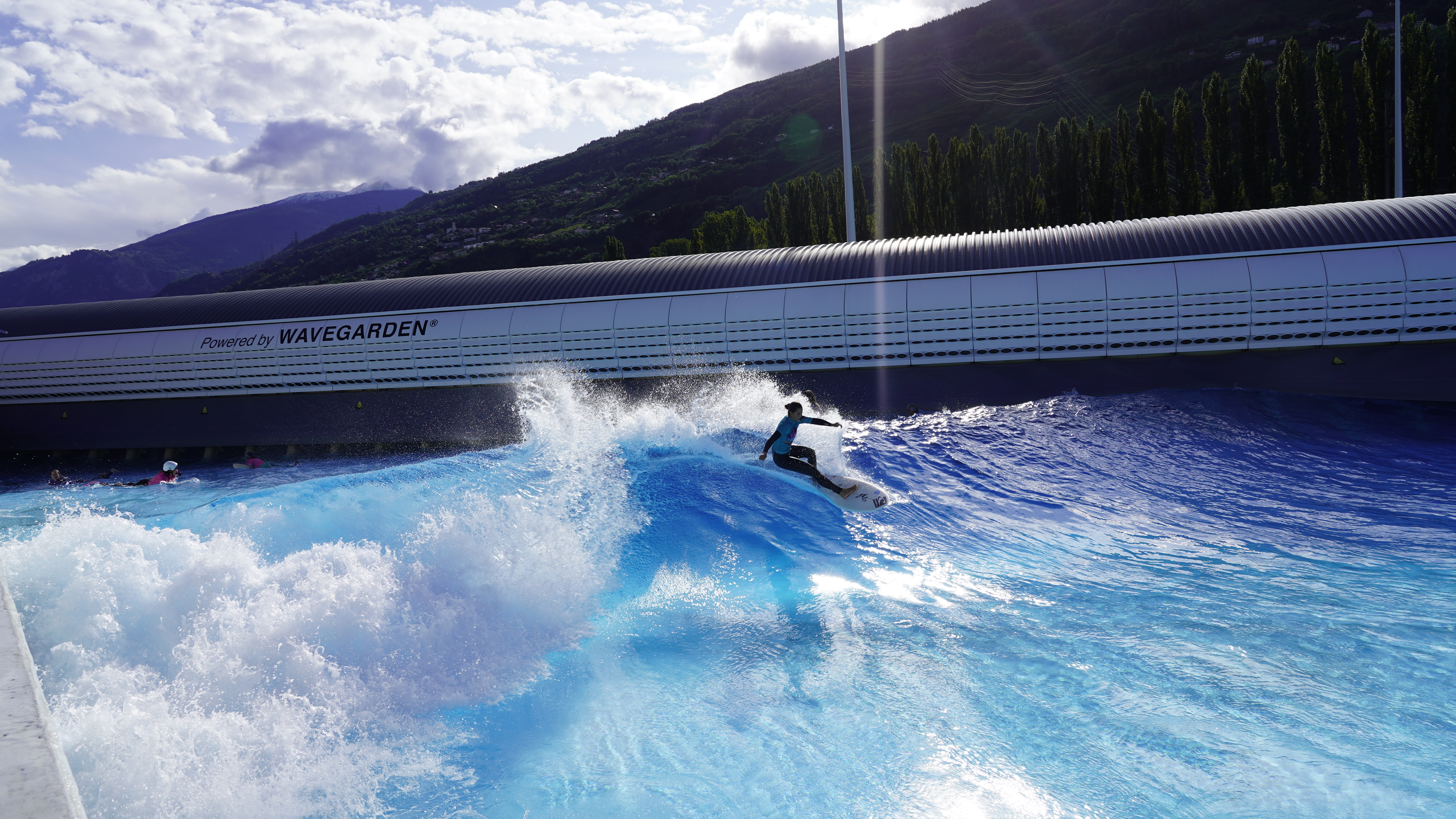 Surfer riding a wave at a wavegarden cove