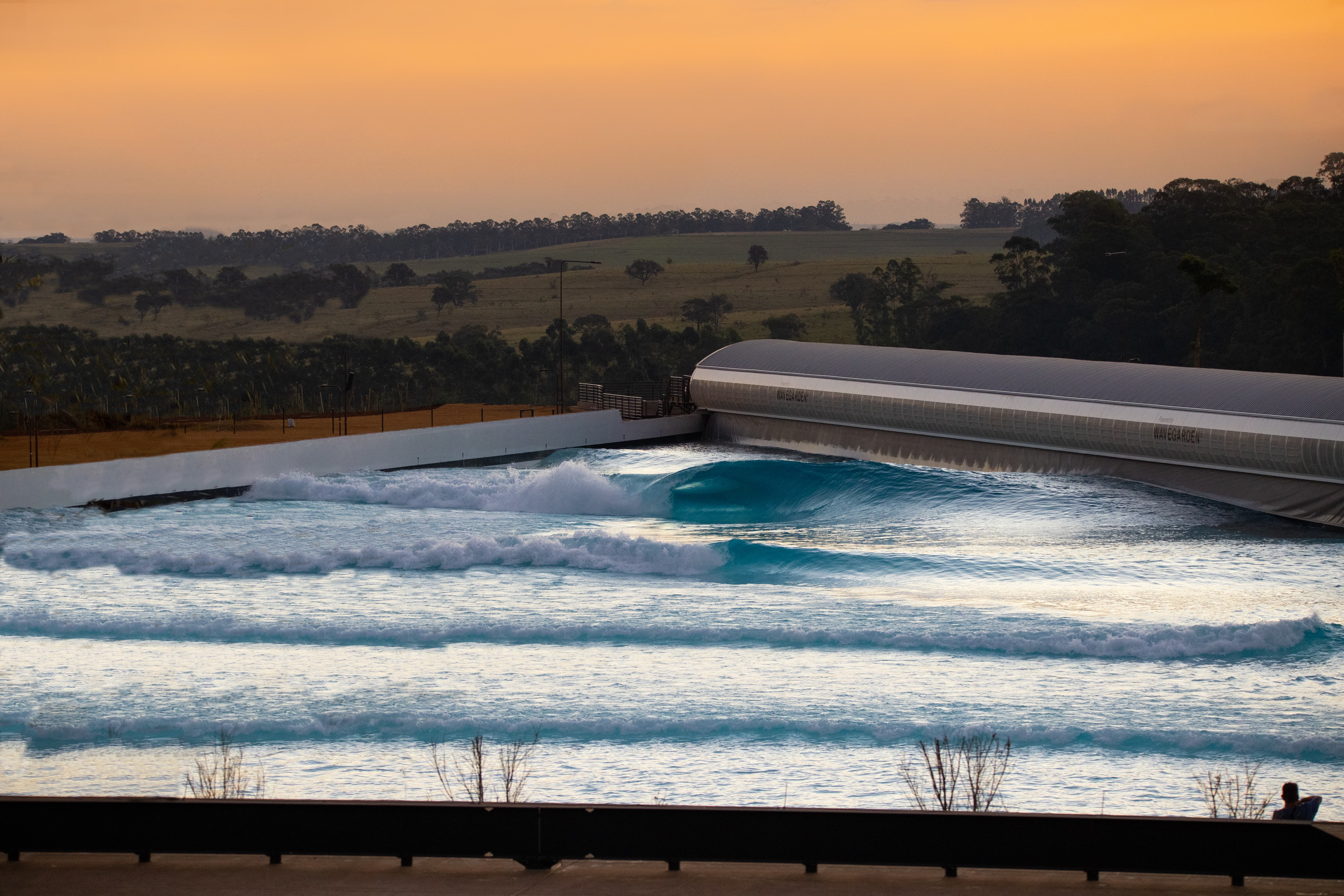 Wavegarden cove with waves at sunset