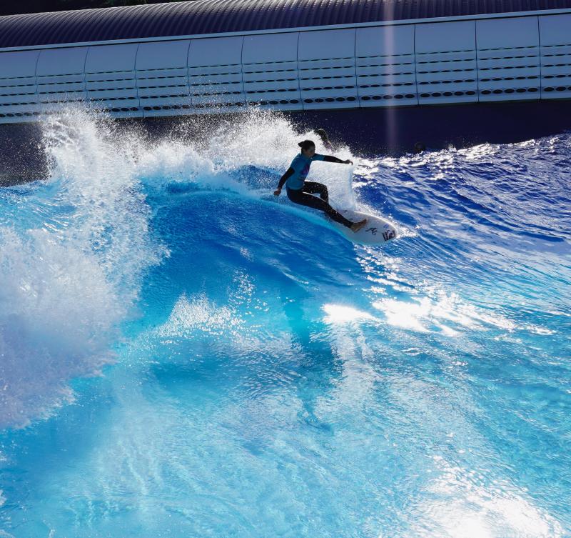 Surfer riding a wave at a wavegarden cove